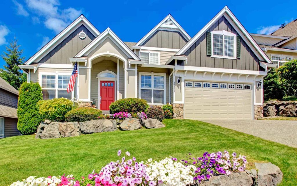 residential home with two toned color and red door- does painting a house exterior increase value